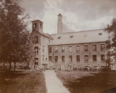 Group of people outside the old mill before it became Phoenix Park